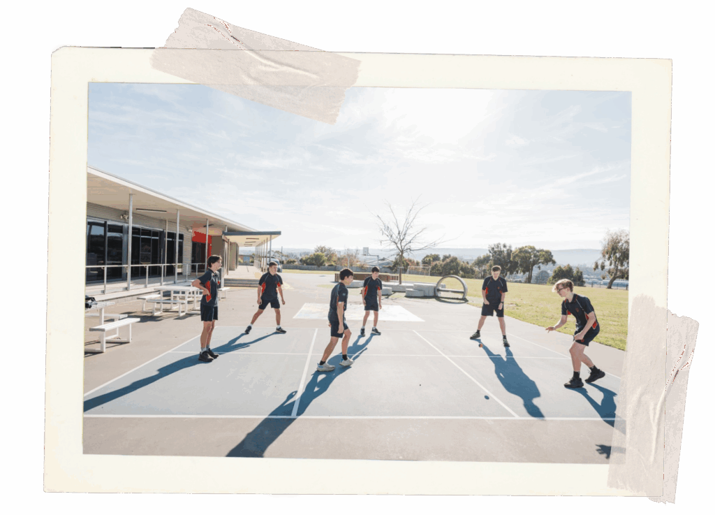 Children playing handball outside. The square is 3x2 which is unusual for handball, unclear who is king, queen, dunce.