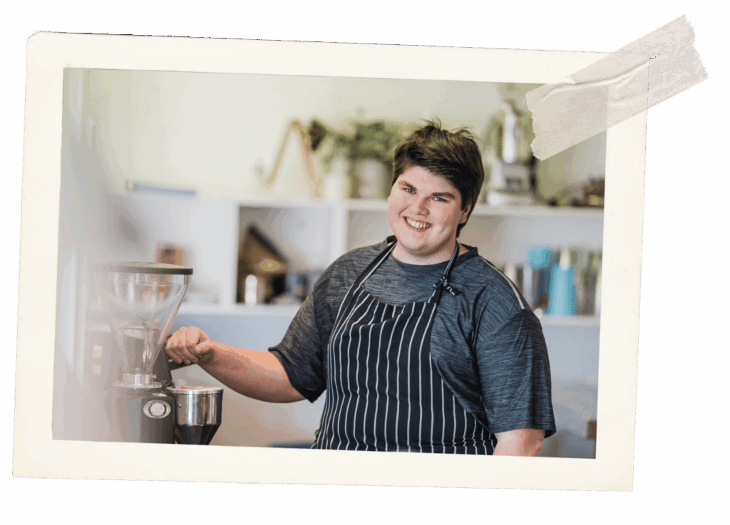 Student smiling making coffee