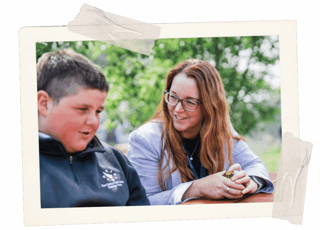 Teacher/support person speaking with a child.